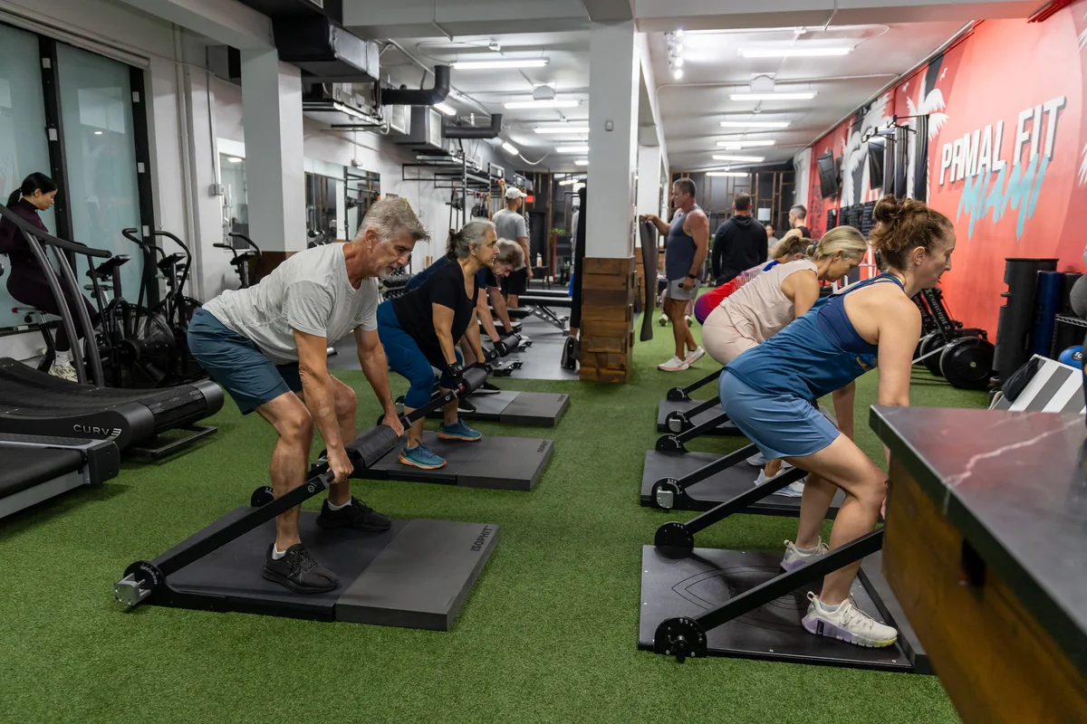Prime Strength 30 ISOPHIT Group Training Adults 50+ performing coached ISOPHIT strength training at Primal Fit Miami